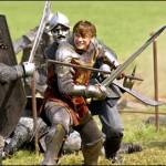 William holding a spear like weapon.